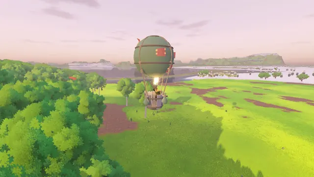 A hot-air balloon rising over the forest toward the coast